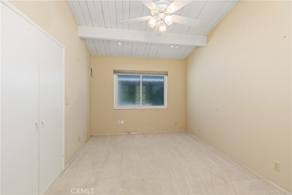 223 Orange Street Newport Beach, CA 92663 - Photo 32 of 51 an empty room with a chandelier fan and windows