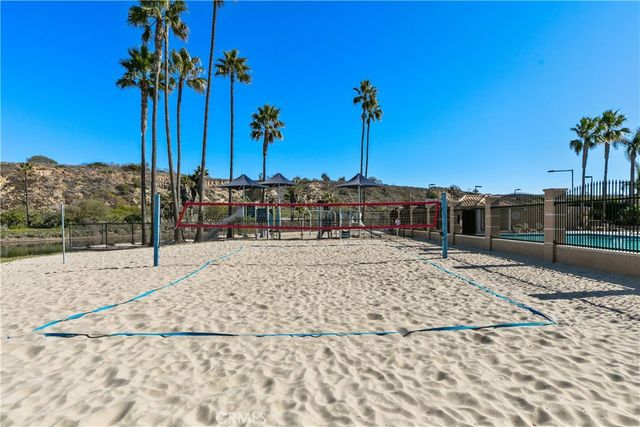 a view of a patio with a table and chairs under an umbrella