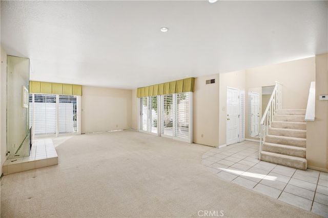 a view of a livingroom with wooden floor and a fireplace