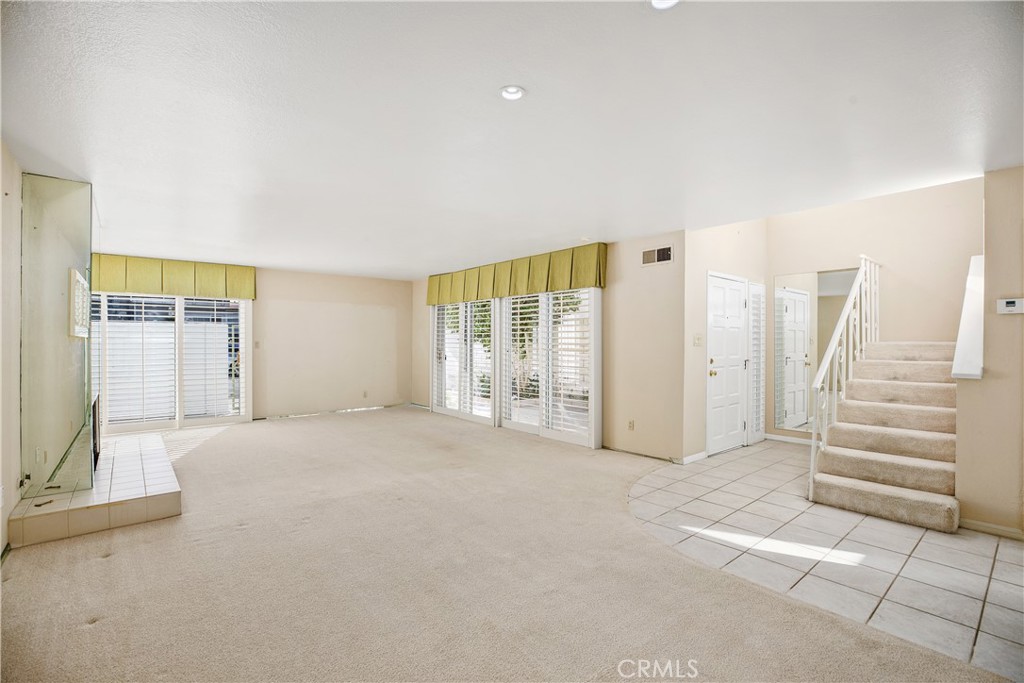 223 Orange Street Newport Beach, CA 92663 - Photo 9 of 51 a view of an empty room with wooden floor and windows