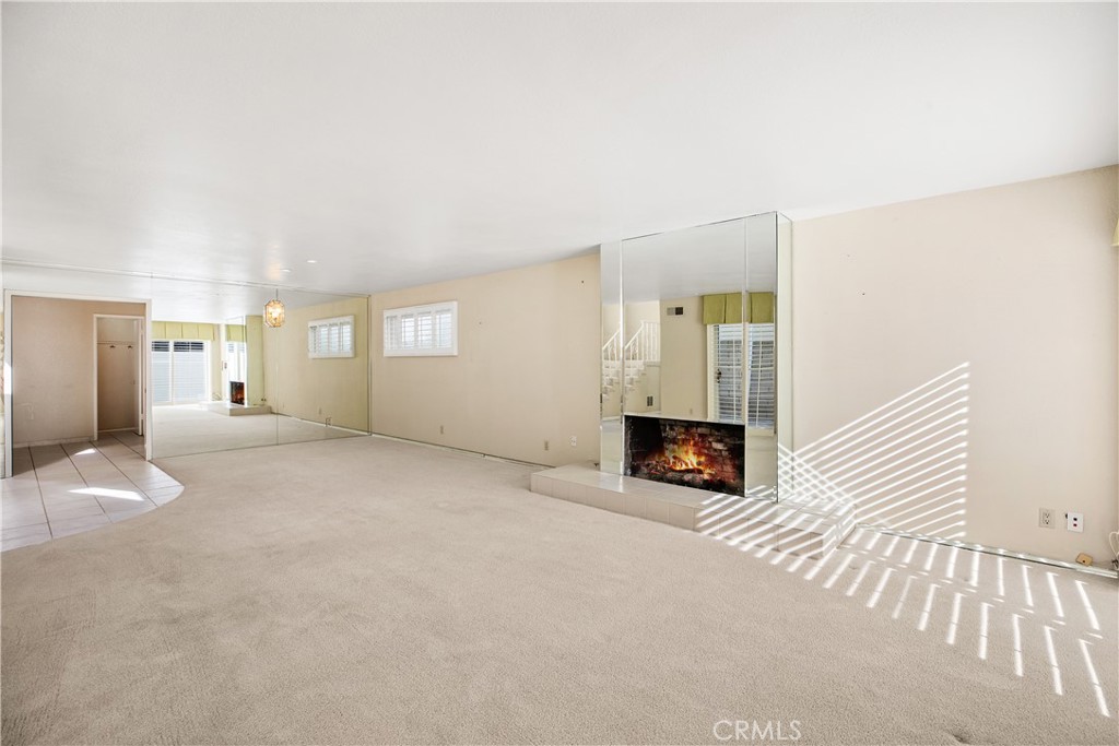223 Orange Street Newport Beach, CA 92663 - Photo 10 of 51 a view of a livingroom with wooden floor and a fireplace