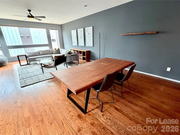 a living room with dining room and wooden floor