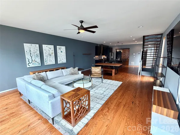 a living room with furniture and a wooden floor