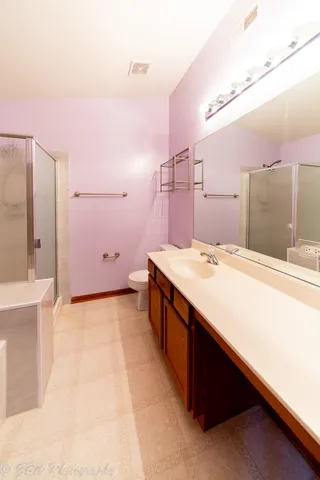 a spacious bathroom with a sink and a mirror