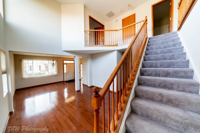 a view of entryway and hall with wooden floor