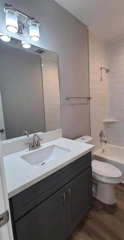 9114 Caddo Road, Unit A & B Houston, TX 77078 - Photo 8 of 24 Bathroom 1 - featuring a dark gray vanity with a light countertop, an integrated sink, and a brushed nickel faucet