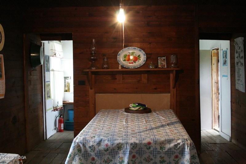 962 Durden Road Sandersville, GA 31082 - Photo 10 of 19 a bedroom with a bed and a closet with wooden floor