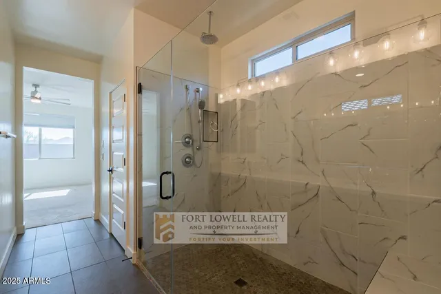 a bathroom with a shower and a sink