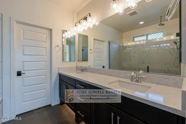 a bathroom with a sink a double vanity and a mirror