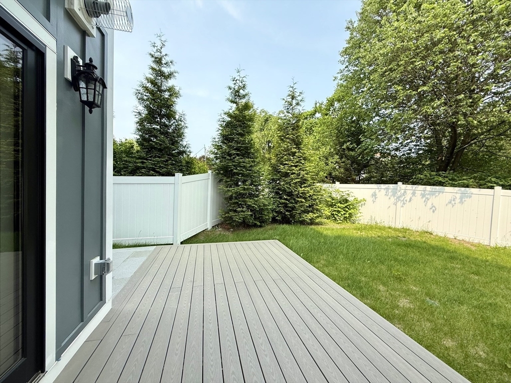 809-811 Heath Street, Unit 811 Brookline, MA 02467 - Photo 14 of 35 a view of backyard with a garden and trees