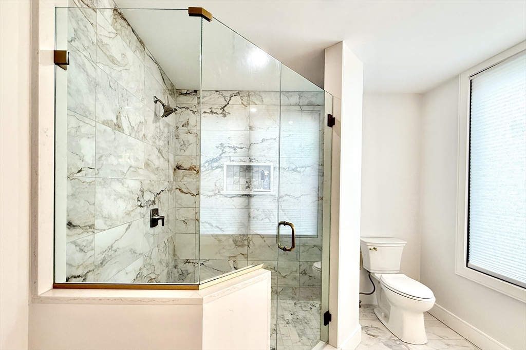 809-811 Heath Street, Unit 811 Brookline, MA 02467 - Photo 16 of 35 a bathroom with a sink and a shower