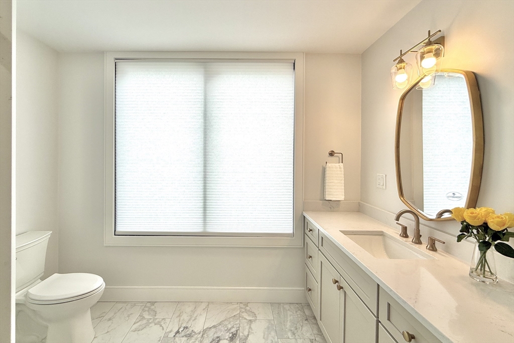 809-811 Heath Street, Unit 811 Brookline, MA 02467 - Photo 17 of 35 a bathroom with a sink and a mirror