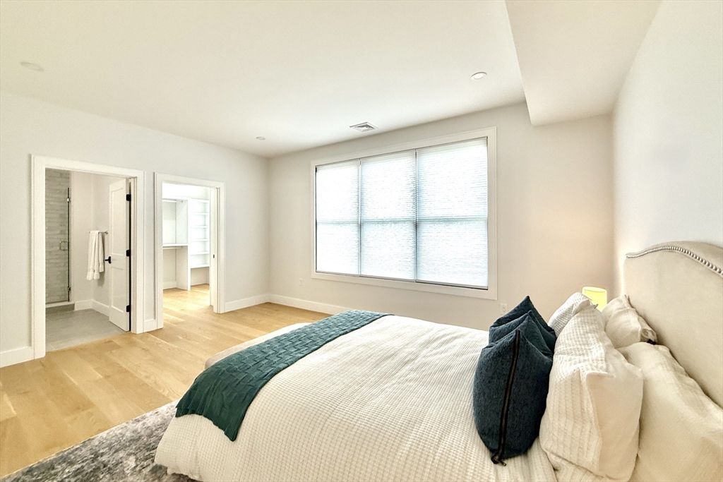 809-811 Heath Street, Unit 811 Brookline, MA 02467 - Photo 23 of 35 a spacious bedroom with a bed and a window