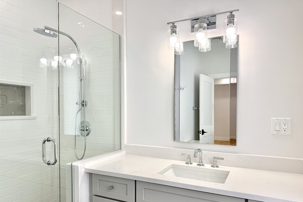 809-811 Heath Street, Unit 811 Brookline, MA 02467 - Photo 24 of 35 a bathroom with a sink and a mirror