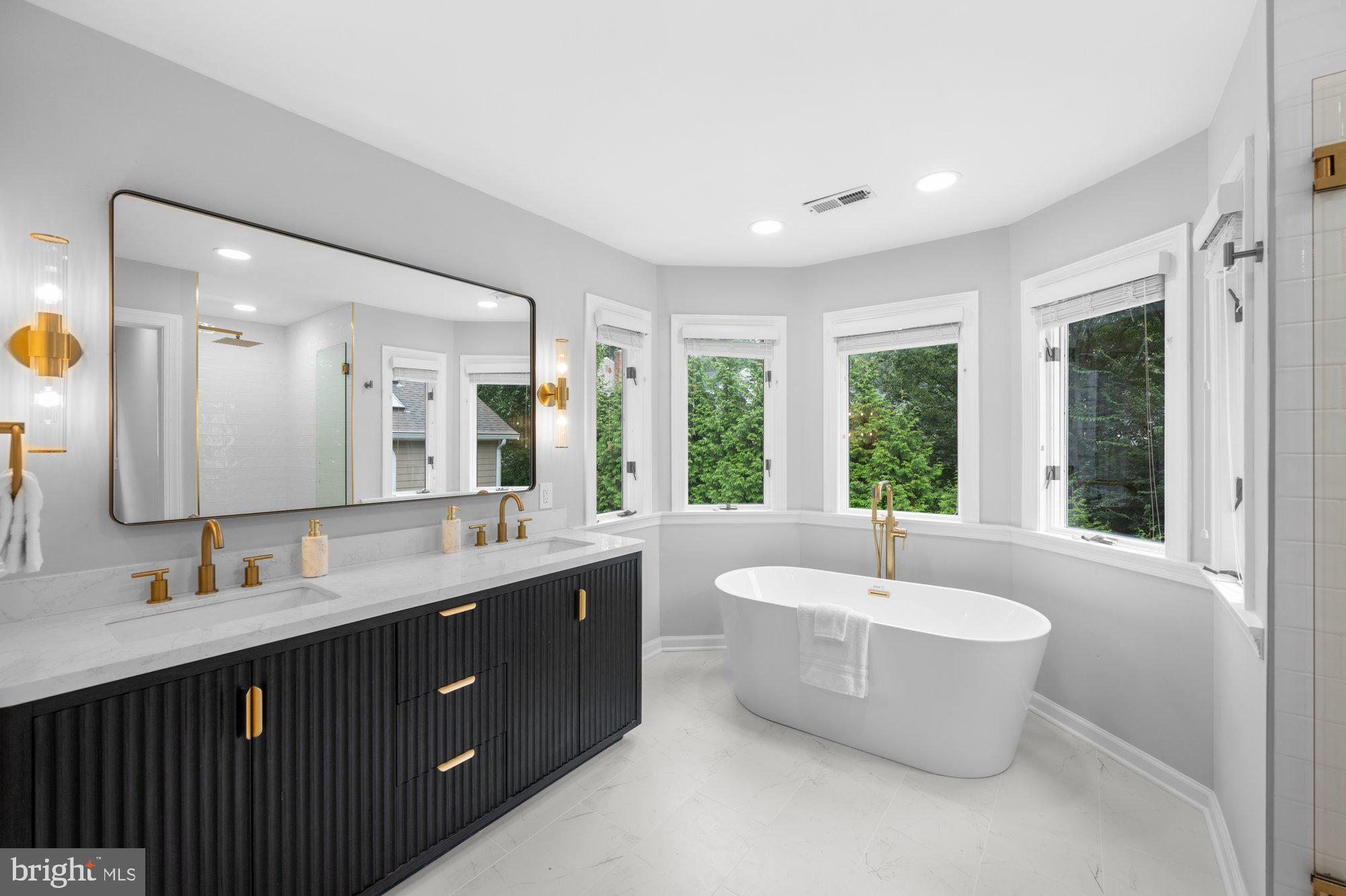 6856 St Albans Road McLean, VA 22101 - Photo 21 of 45 a spacious bathroom with a double vanity sink large mirror and bathtub