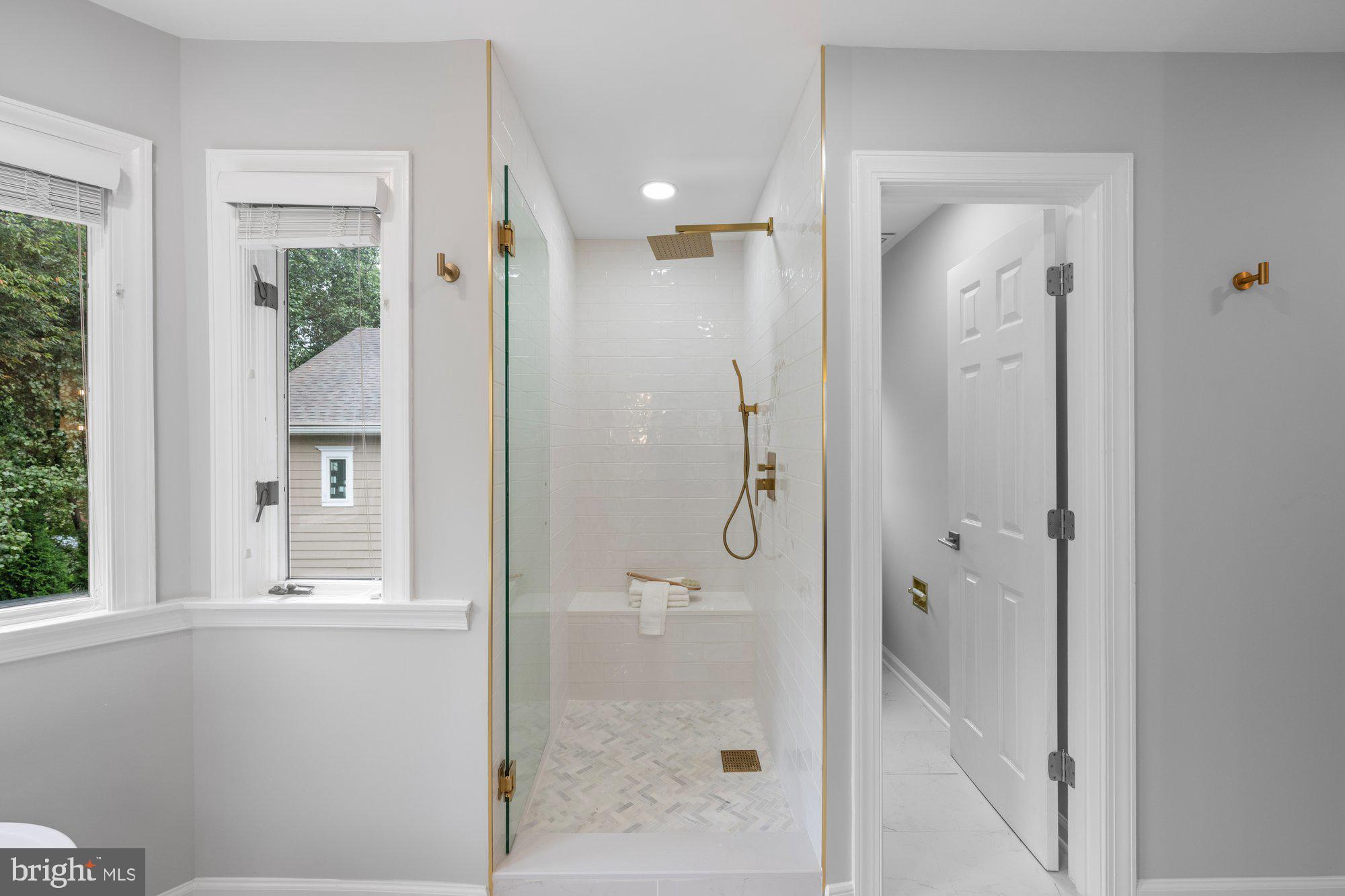 6856 St Albans Road McLean, VA 22101 - Photo 22 of 45 a bathroom with a glass shower door and a sink