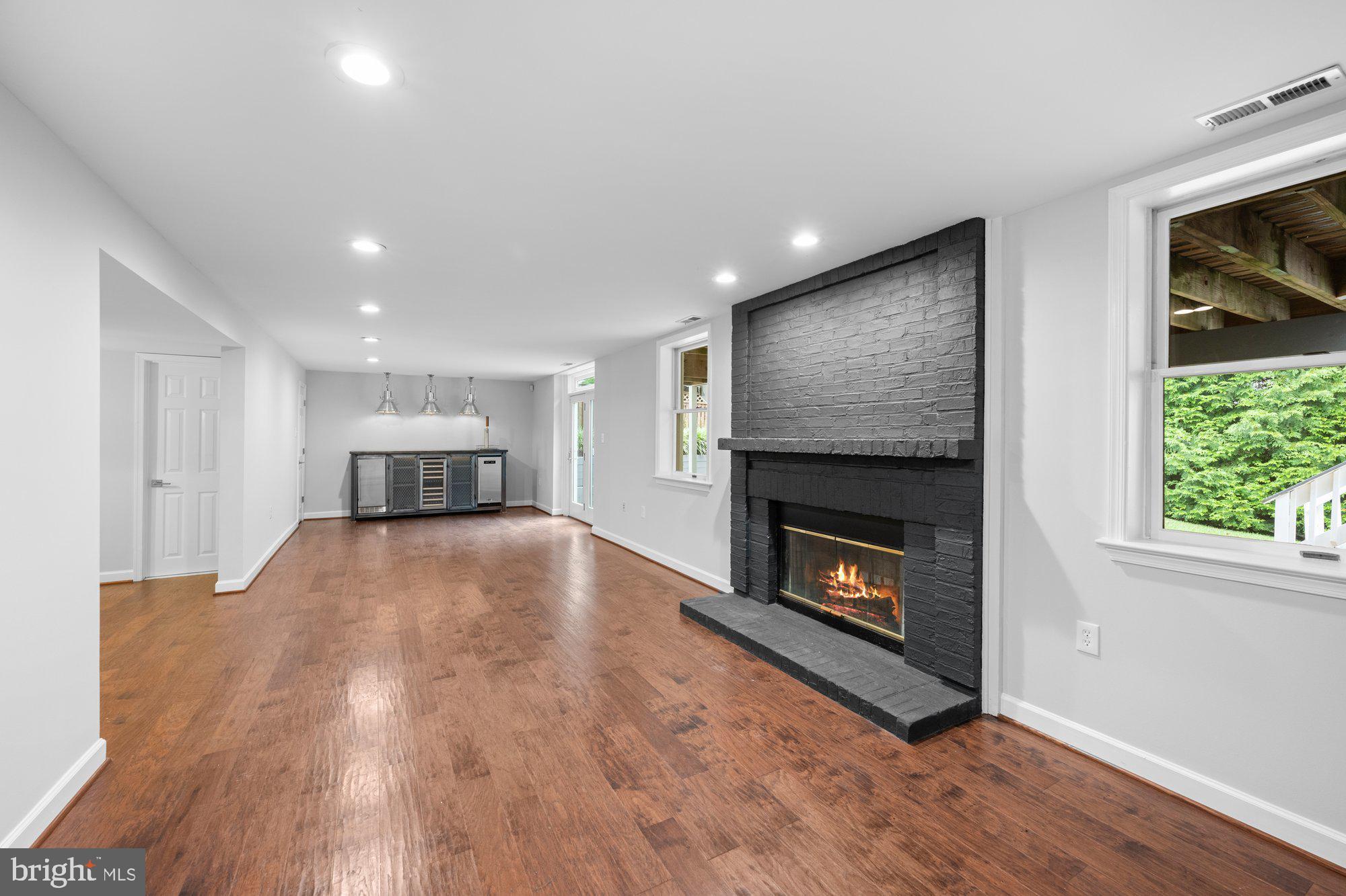 6856 St Albans Road McLean, VA 22101 - Photo 32 of 45 a view of an empty room with wooden floor fireplace and a window