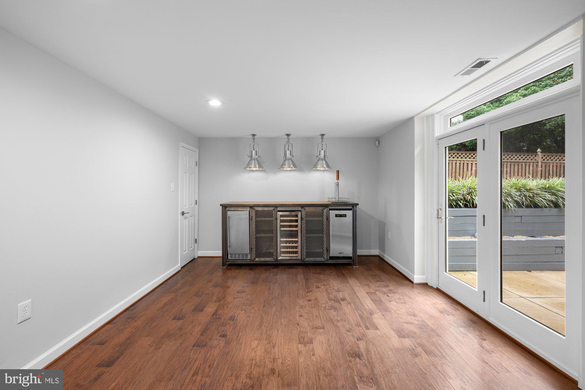 6856 St Albans Road McLean, VA 22101 - Photo 33 of 45 an empty room with wooden floor and windows