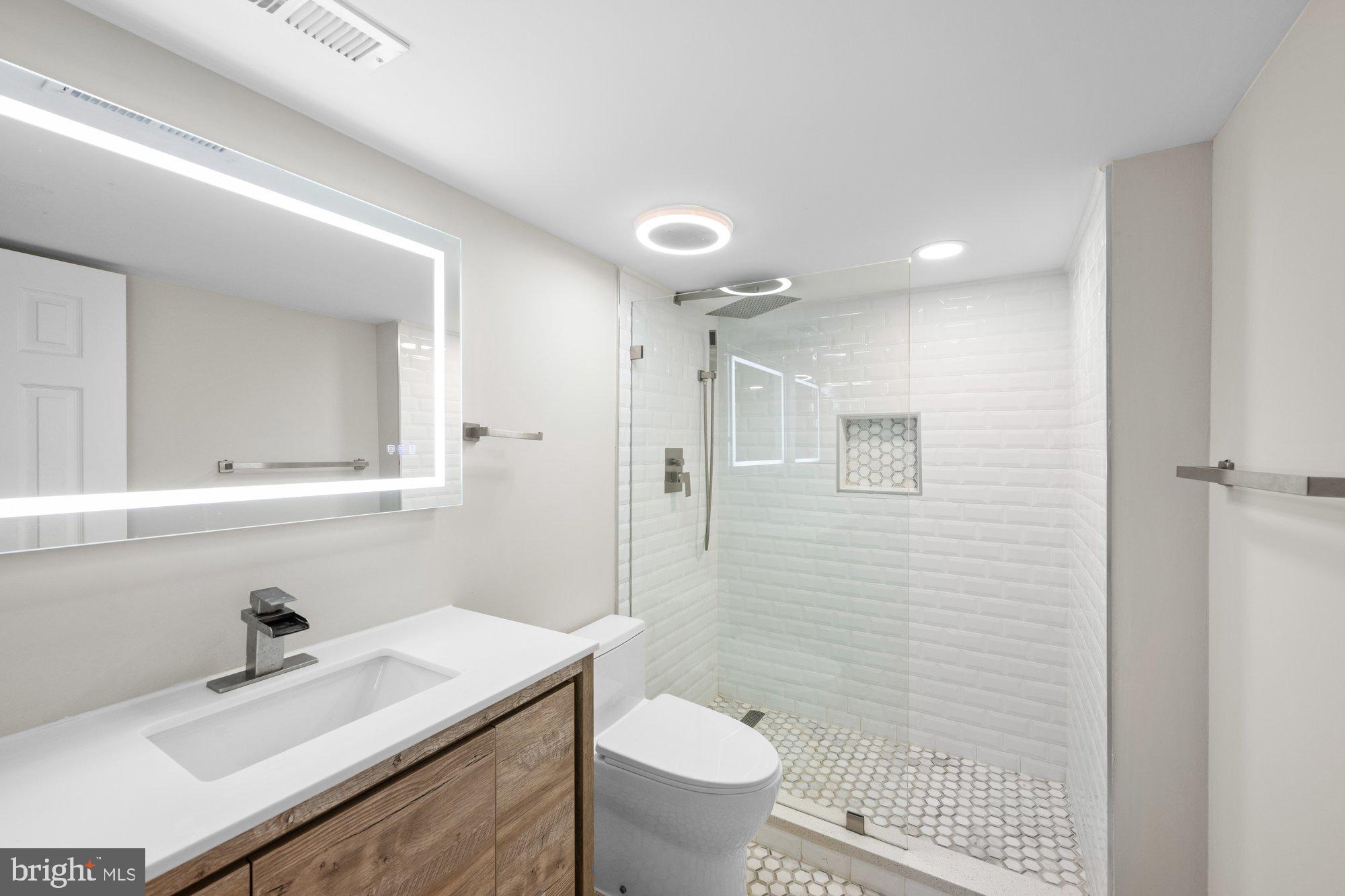6856 St Albans Road McLean, VA 22101 - Photo 35 of 45 a bathroom with a sink toilet vanity and shower