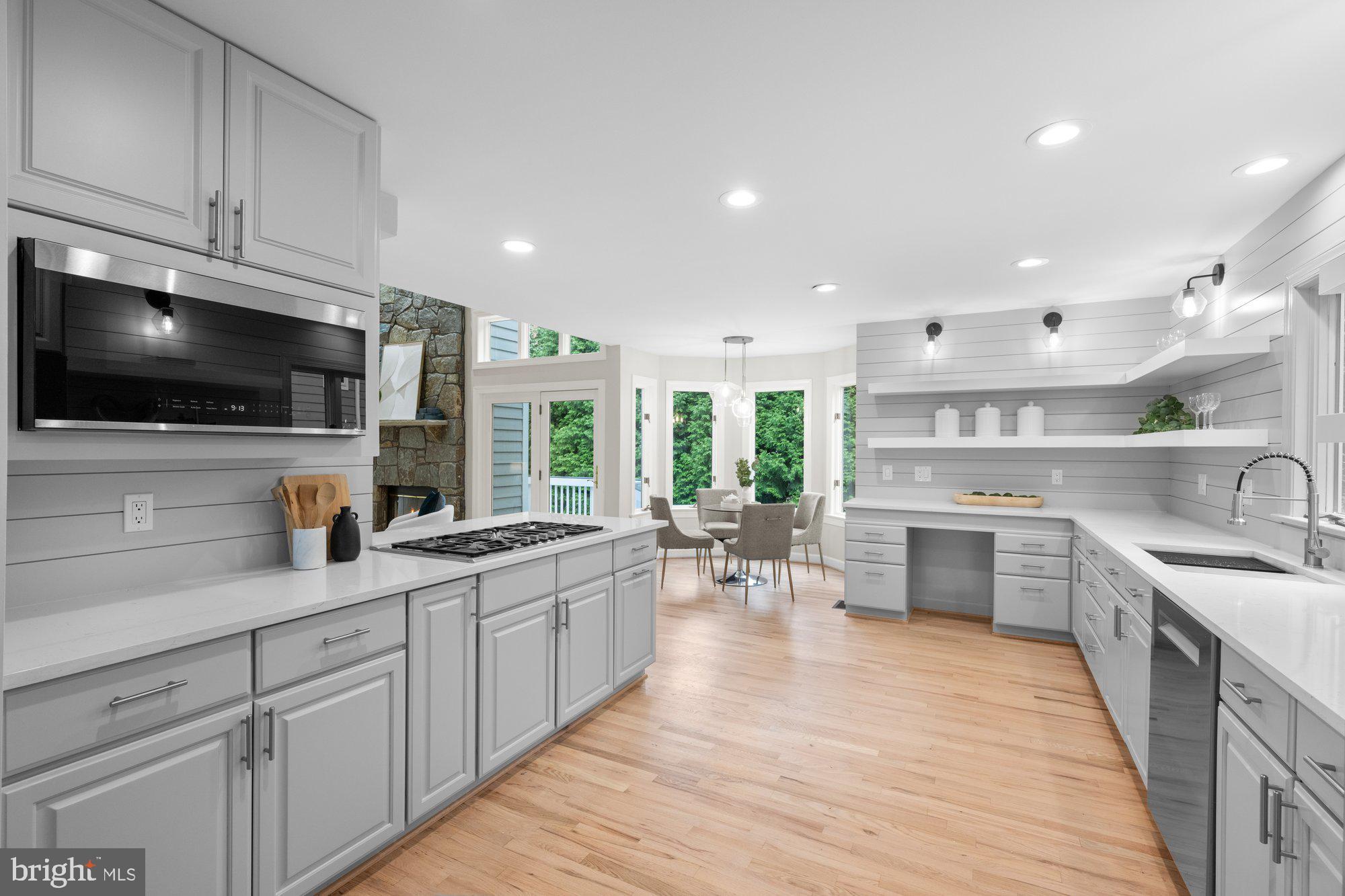 6856 St Albans Road McLean, VA 22101 - Photo 9 of 45 a kitchen with stainless steel appliances kitchen island granite countertop a sink counter space cabinets and a view of living room