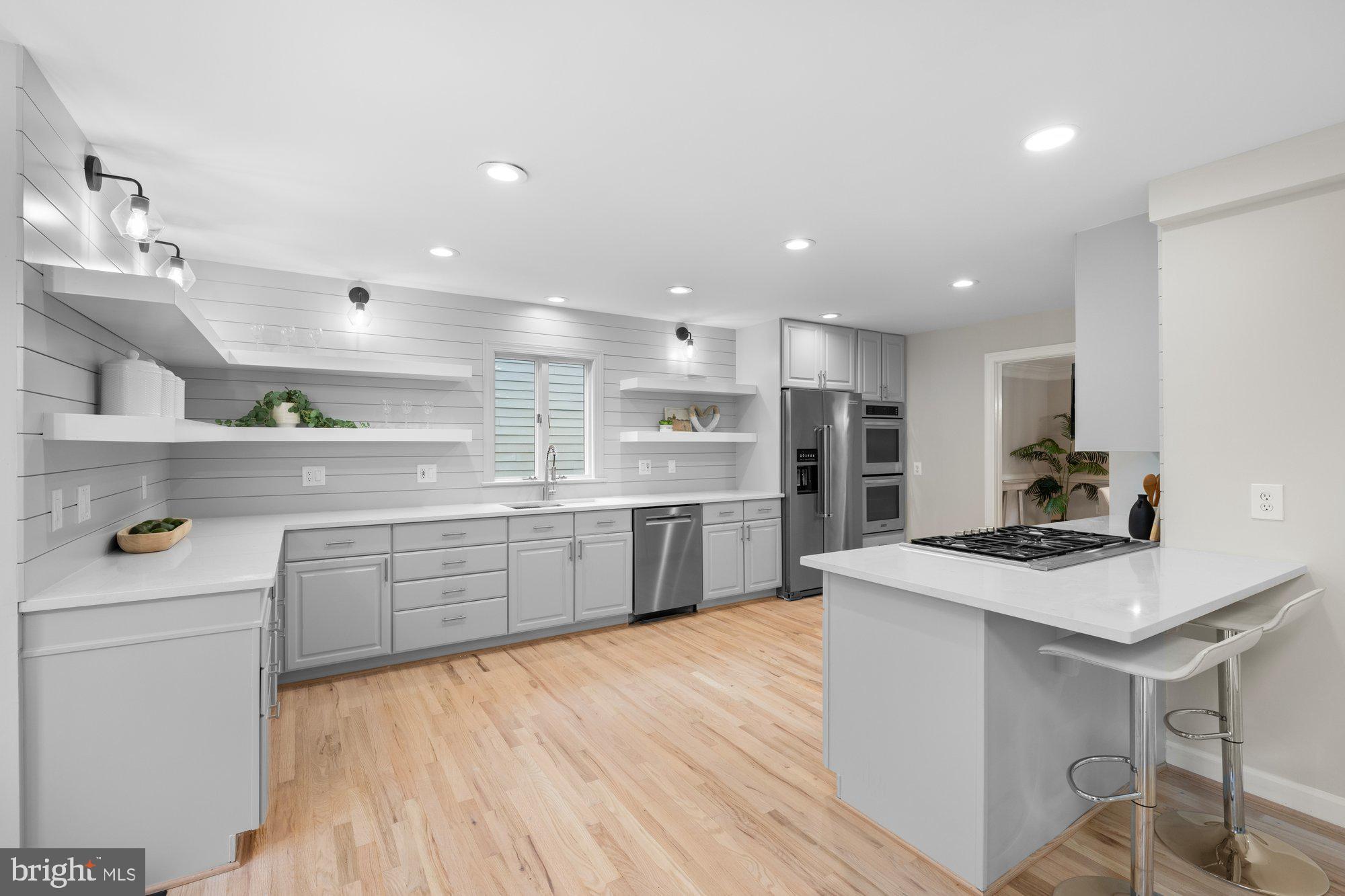 6856 St Albans Road McLean, VA 22101 - Photo 10 of 45 a kitchen with kitchen island white cabinets and stainless steel appliances