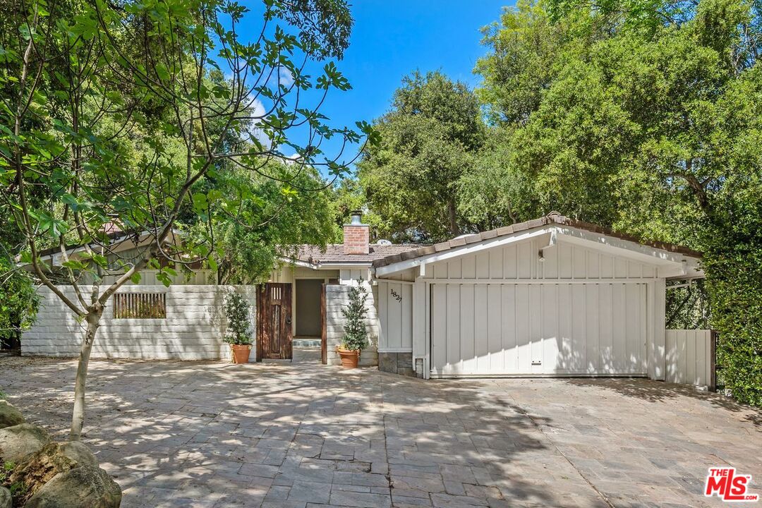 1827 Old Ranch Road Los Angeles, CA 90049 - Photo 1 of 39 a view of a house with a yard and garage