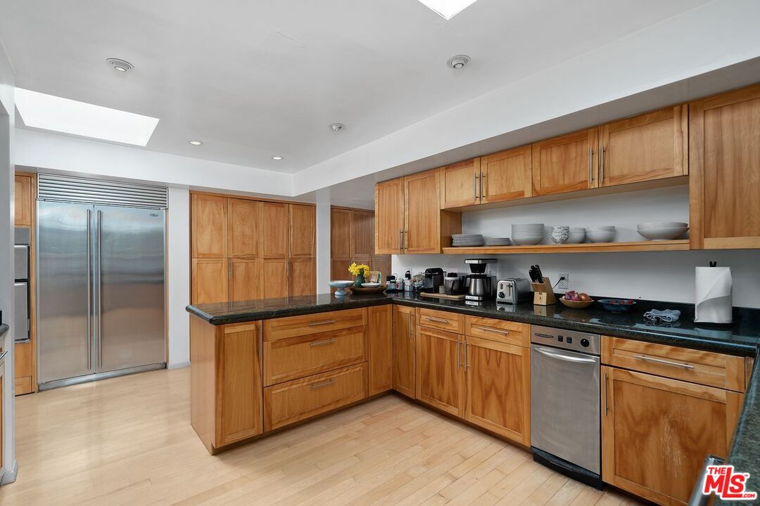 1827 Old Ranch Road Los Angeles, CA 90049 - Photo 13 of 39 a kitchen with stainless steel appliances granite countertop a sink a stove and refrigerator