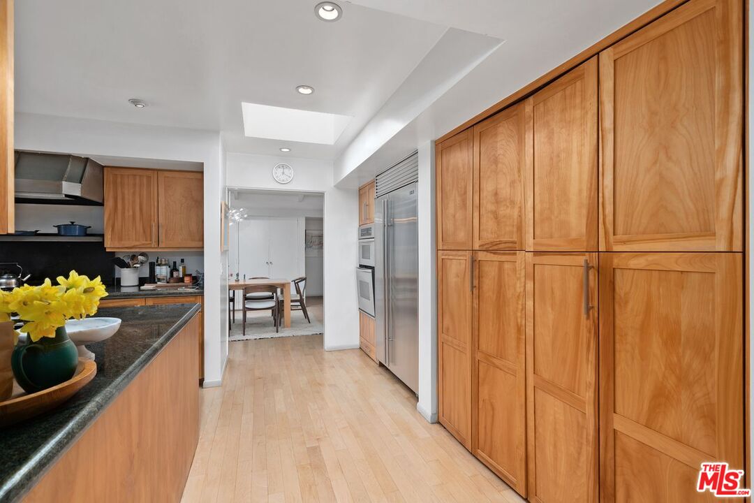 1827 Old Ranch Road Los Angeles, CA 90049 - Photo 14 of 39 a kitchen with stainless steel appliances granite countertop a refrigerator and a stove top oven