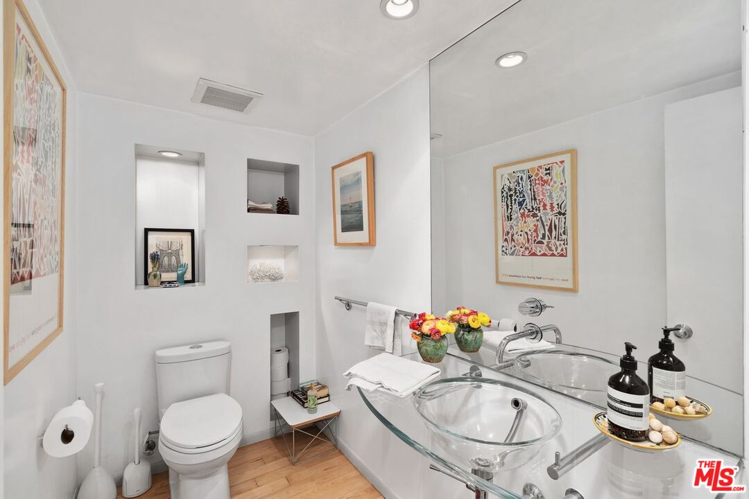 1827 Old Ranch Road Los Angeles, CA 90049 - Photo 15 of 39 a bathroom with a sink mirror and toilet