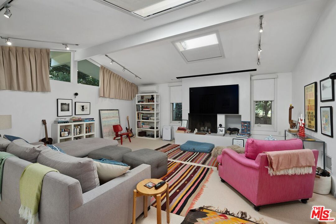 1827 Old Ranch Road Los Angeles, CA 90049 - Photo 16 of 39 a living room with furniture and a flat screen tv