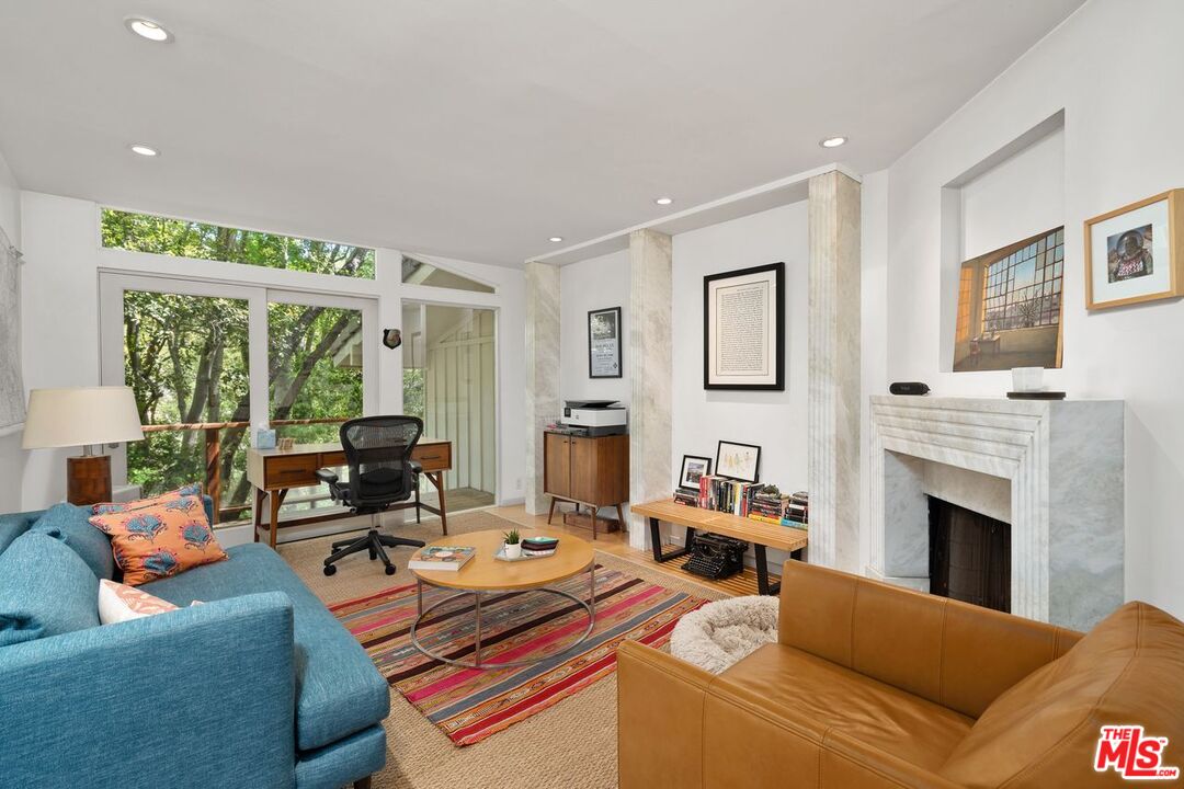 1827 Old Ranch Road Los Angeles, CA 90049 - Photo 19 of 39 a living room with furniture fireplace and a large window