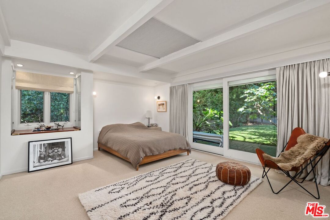 1827 Old Ranch Road Los Angeles, CA 90049 - Photo 21 of 39 a bedroom with a bed and a large window