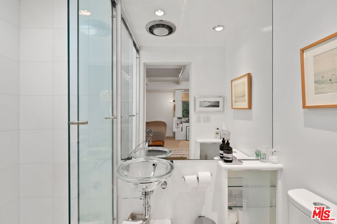 1827 Old Ranch Road Los Angeles, CA 90049 - Photo 22 of 39 a bathroom with a sink mirror and vanity