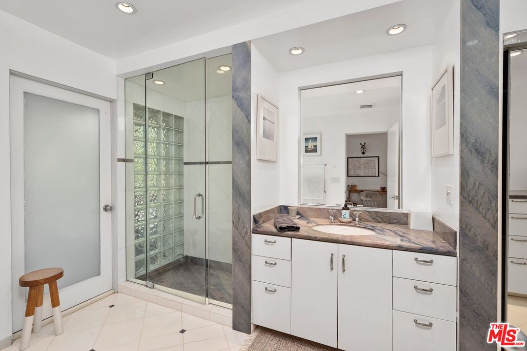 1827 Old Ranch Road Los Angeles, CA 90049 - Photo 24 of 39 a spacious bathroom with a shower sink and mirror