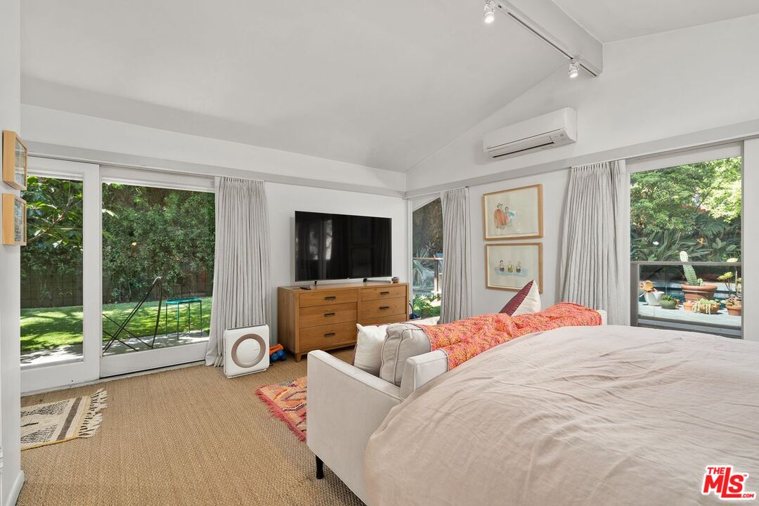 1827 Old Ranch Road Los Angeles, CA 90049 - Photo 26 of 39 a bedroom with furniture and a large window