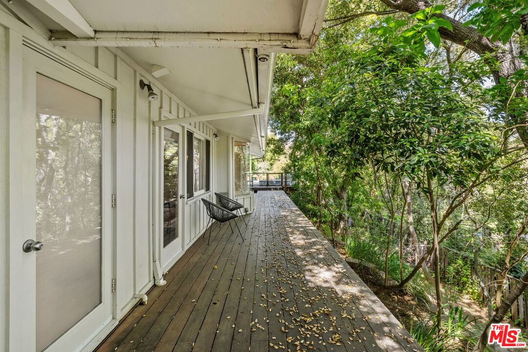 1827 Old Ranch Road Los Angeles, CA 90049 - Photo 33 of 39 a view of a house with a glass door and deck