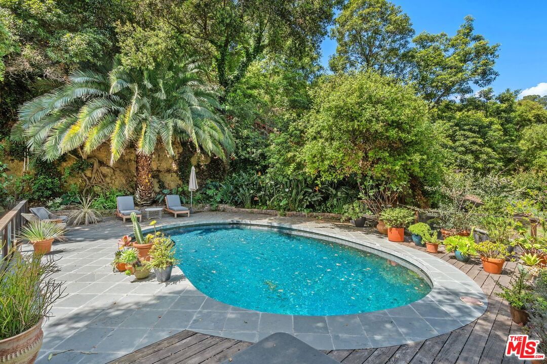 1827 Old Ranch Road Los Angeles, CA 90049 - Photo 34 of 39 a view of a swimming pool with an outdoor seating