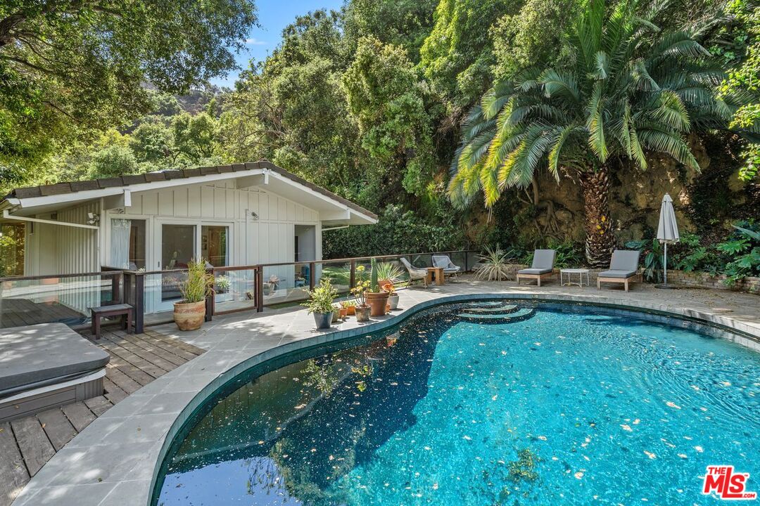 1827 Old Ranch Road Los Angeles, CA 90049 - Photo 35 of 39 a view of a house with swimming pool and sitting area