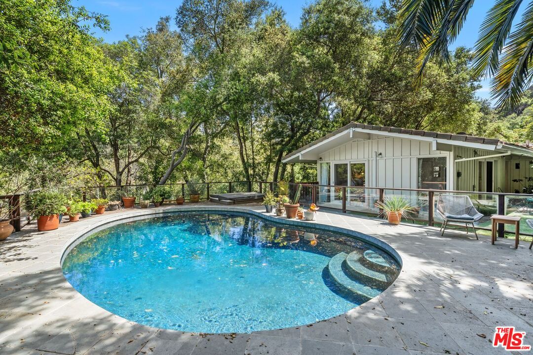 1827 Old Ranch Road Los Angeles, CA 90049 - Photo 36 of 39 a swimming pool with outdoor seating