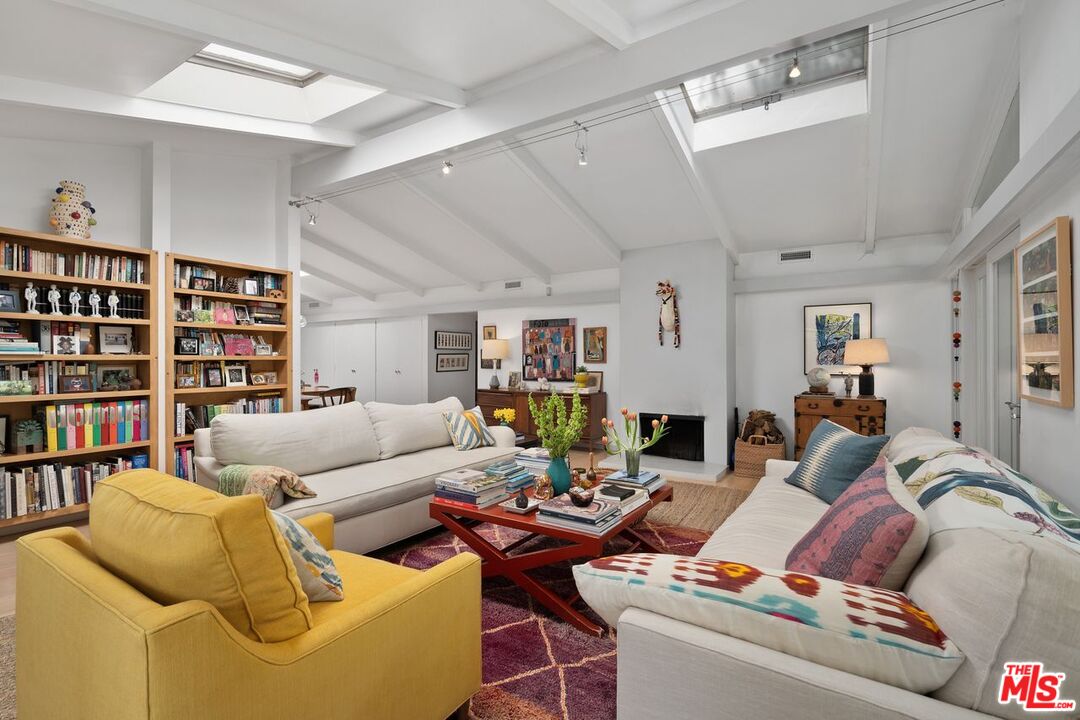 1827 Old Ranch Road Los Angeles, CA 90049 - Photo 8 of 39 a living room with furniture and a book shelf