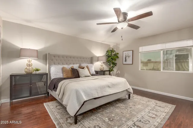 a bedroom with a large bed and a chandelier