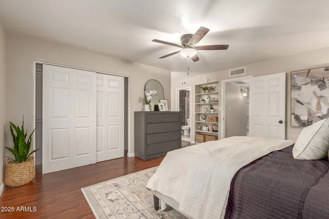 a bedroom with a bed and a potted plant