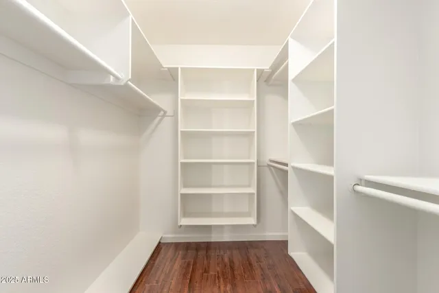 a view of walk in closet with empty racks