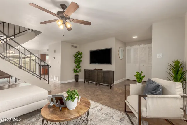 a living room with furniture and a flat screen tv