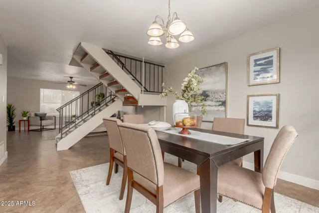 a view of a dining room with furniture and a chandelier
