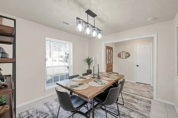 a view of a dining room with a table and chairs