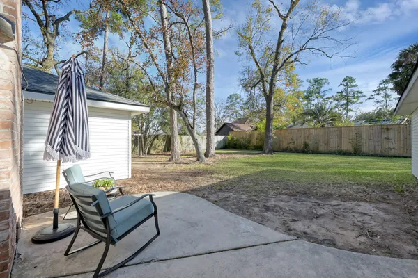 a backyard of a house with table and chairs