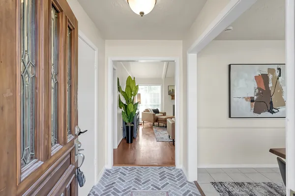 a view of a hallway view with wooden floor and a livingroom view