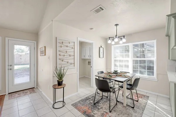a dining room with furniture and window