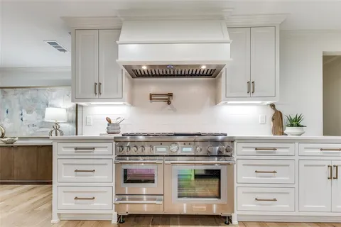 a kitchen with granite countertop a stove and a sink